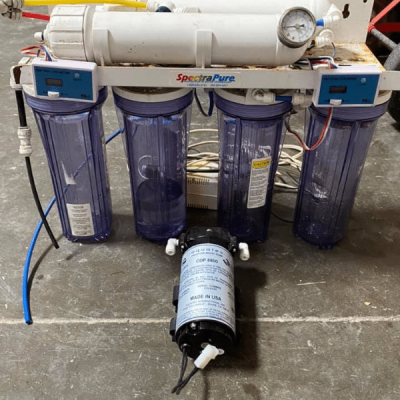 Saltwater aquarium filter system under the tank showing plumbing and components