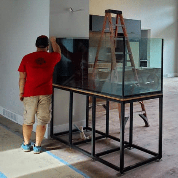 OCD Reefs technician installing reef system equipment in a residential home