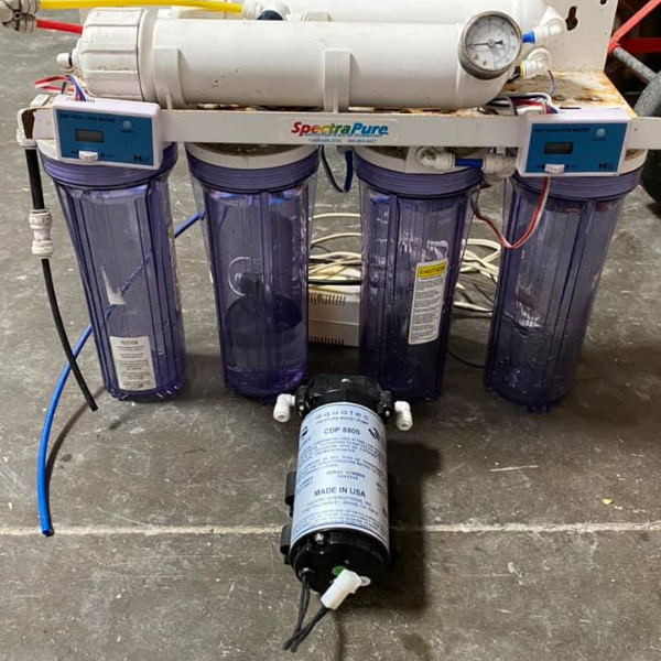 Saltwater aquarium filter system under the tank showing plumbing and components